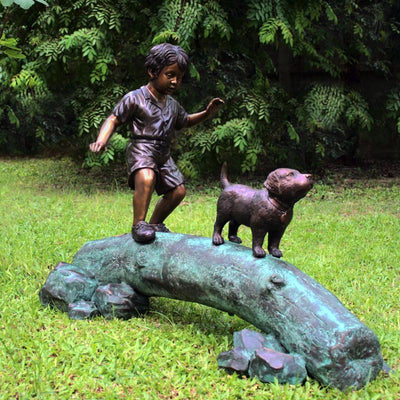 Brass Baron Boy Following Dog Across Log Outdoor Statue
